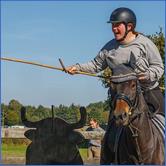 A person riding a horse with a stick

Description automatically generated